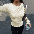 French-style Niche Off-white Top For Women Irregularly Crossed Pleated Design On The Front Chest Long Sleeves Loose Fit And Figure-flattering